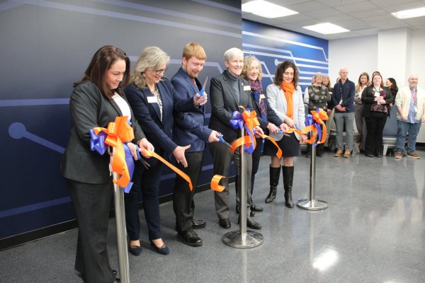 President Stephanie Nesbitt and members of the Utica University Community cut the ribbon on the new Cyber Range.